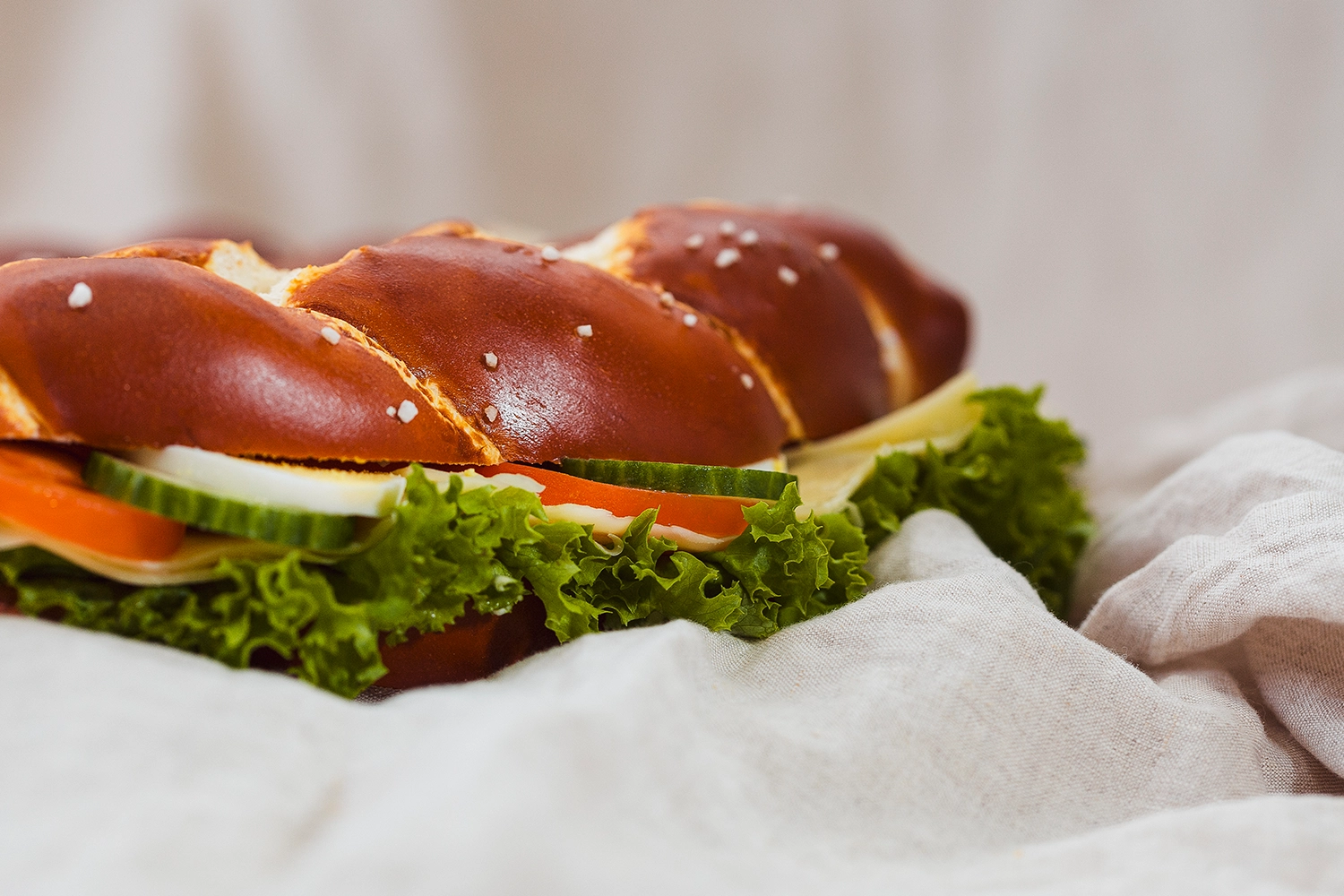 Nahaufnahme der großen, belegten Partybreze. Zu erkennen sind Gurken, Tomaten, Eier, Salat und Käse.