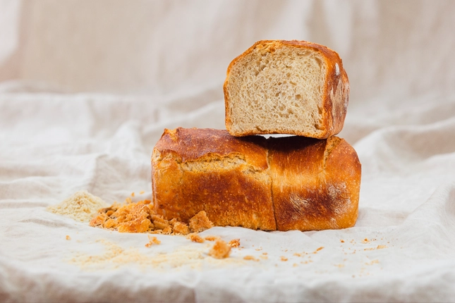 Aufgeschnittenes Brot mit Brotbröseln für die Paniermehlverarbeitung